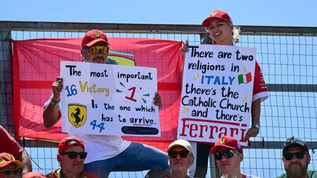 Ferrari fans holding up signs in Imola