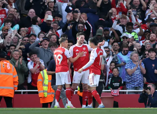 Arsenal's Declan Rice celebrates scoring their first goal with Leandro Trossard and Gabriel Martinelli.