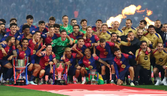 FC Barcelona pose with their three trophies