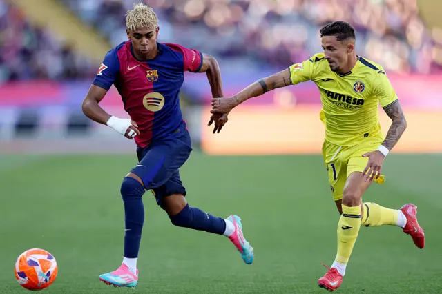 Lamine Yamal runs for the ball