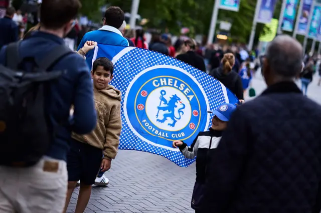 A young Chelsea fan poses for a photo on Wembley way