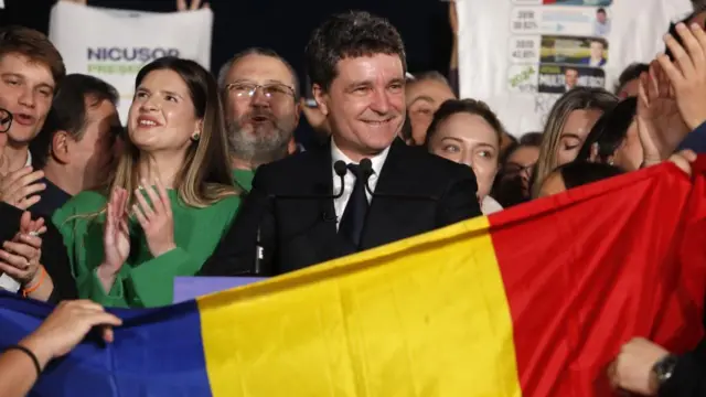 Nicusor Dan (centre) smiles, as his supporters celebrate in Bucharest. Photo: 18 May 2025