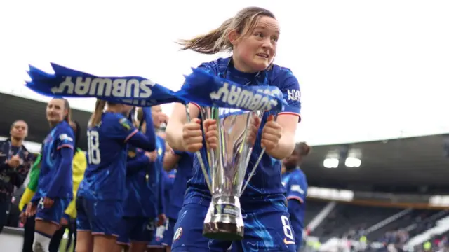 Erin Cuthbert of Chelsea celebrates with the Subway Women's League Cup trophy