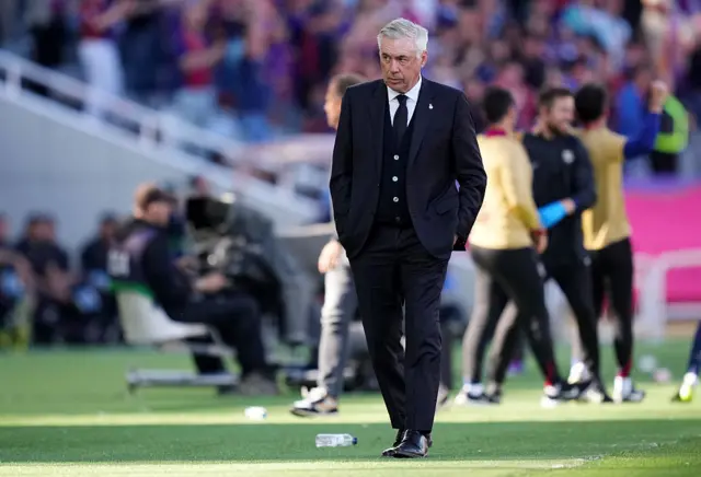 Ancelotti strides along the touchline in Barcelona