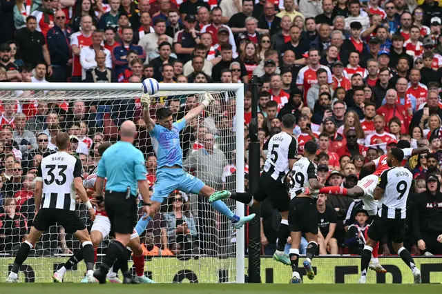 Newcastle United's English goalkeeper #22 Nick Pope makes a reaction save of a header by Arsenal's Ghanaian midfielder #05 Thomas Partey (