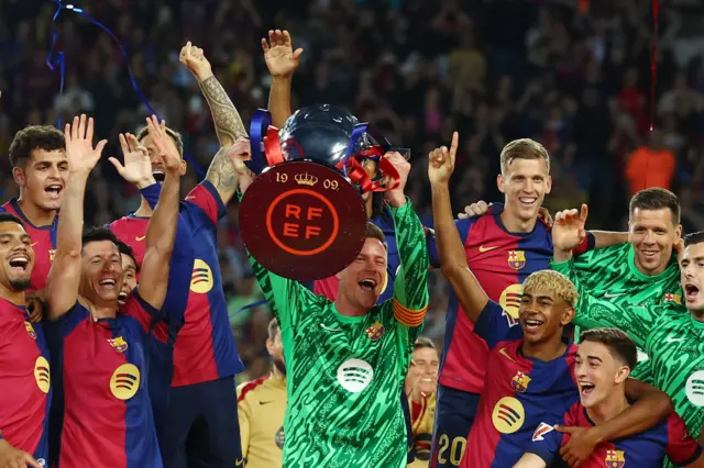 FC Barcelona's Marc-Andre ter Stegen lifts the trophy with teammate