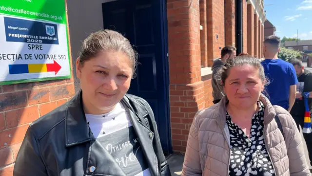 Two women standing outside a polling station