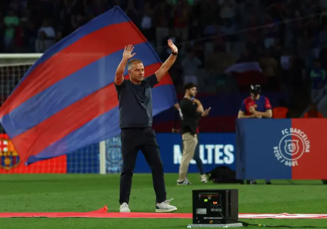 Hansi Flick waves to the fans during the title celebrations