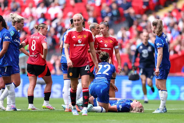 Manchester United and Chelsea players pause for a break in play