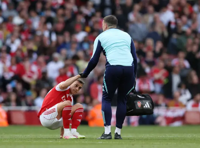 Arsenal's Leandro Trossard receives medical attention after sustaining an injury