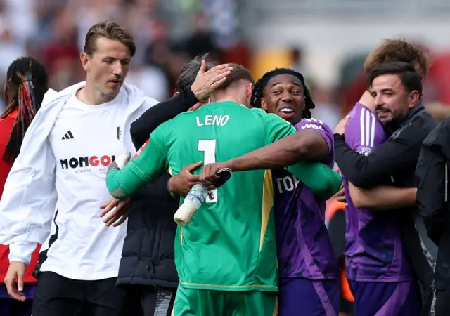Fulham's Bernd Leno and Adama Traore celebrate after the match