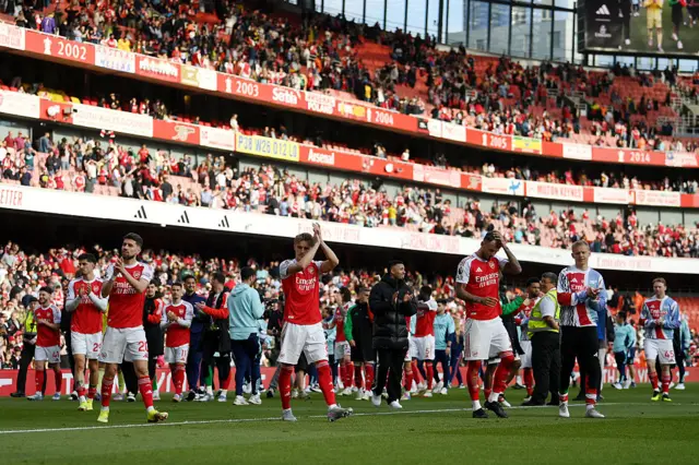 Players of Arsenal acknowledge the fans during a lap of honour
