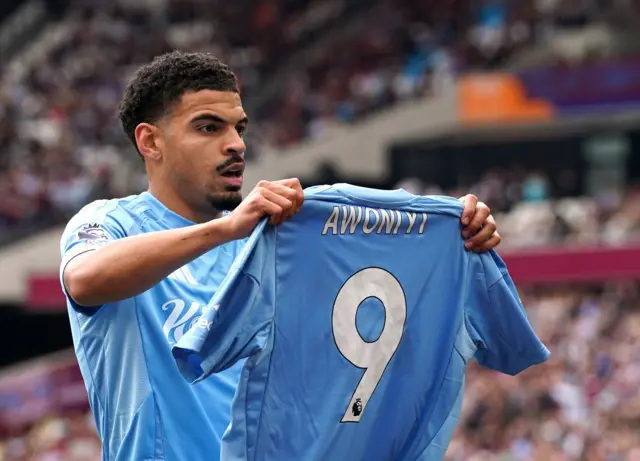 Nottingham Forest's Morgan Gibbs-White celebrates scoring their side's first goal of the game, holding a tribute to team-mate Taiwo Awoniyi,