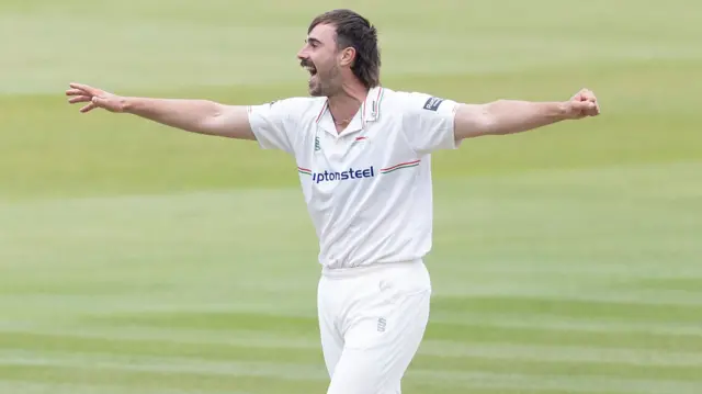 Leics bowler Ben Green celebrates getting out Middlesex's Sam Robson