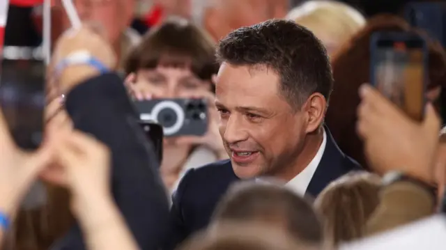 Warsaw Mayor Rafal Trzaskowski in focus surrounded by supporters out of focus