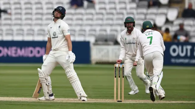 Middlesex's Luke Hollman looks dejected after being bowled out by Leicestershire's Ben Green