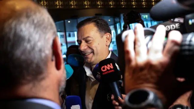 Luis Montenegro surrounded by press as he arrives to wait for exit polls at hotel in Lisbon