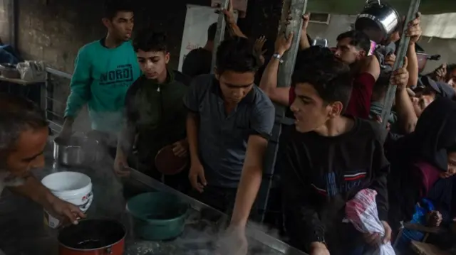 This photo from Sunday shows people getting rations from a charity in Gaza City