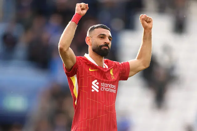 Mohamed Salah with his arms in the air celebrating