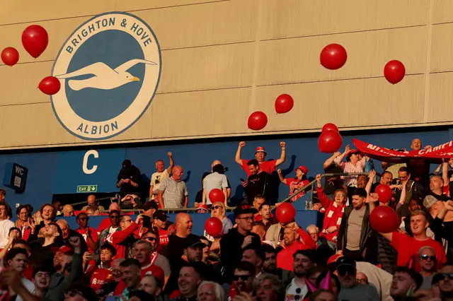 Fans of Liverpool show their support in the stands, by throwing red balloons prior to the Premier League match between Brighton & Hove Albion FC and Liverpool FC at Amex Stadium on May 19, 2025 in Brighton, England.