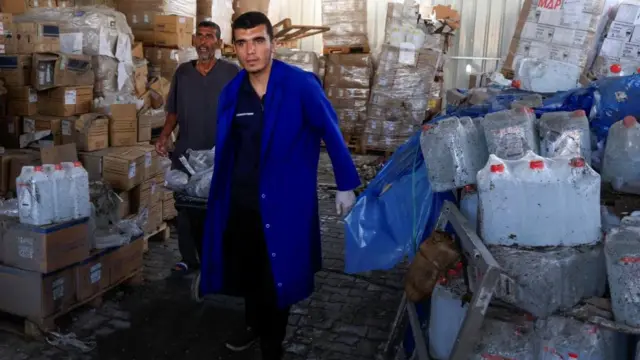 Palestinian staff members walk at the medicine warehouse at Nasser Hospital after an Israeli strike, according to the Gaza Health Ministry, in Khan Younis, southern Gaza Strip, May 19, 2025.