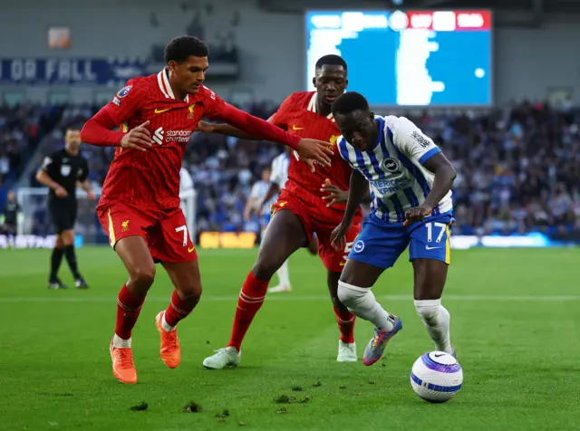 Brighton & Hove Albion's Yankuba Minteh in action with Liverpool's Jarell Quansah and Ibrahima Konat