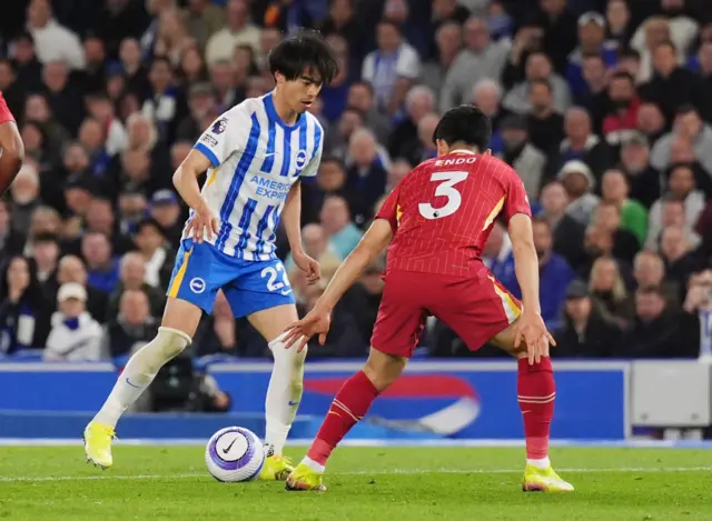 Brighton and Hove Albion's Kaoru Mitoma and Liverpool's Wataru Endo (right) battle for the ball