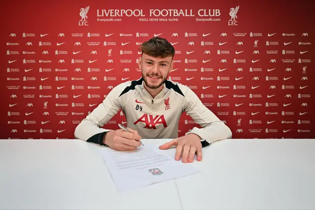 Conor Bradley signing a Liverpool contract