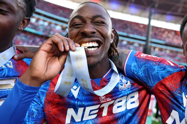 Eberechi Eze biting his FA Cup winners medal