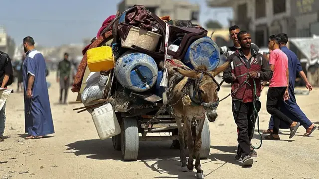 A donkey carries belongings in Khan Younis