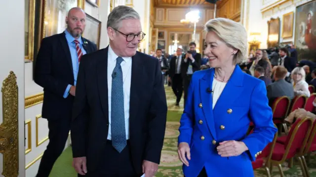 Starmer and Von der Leyen stand and laugh