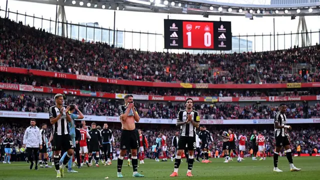Newcastle players applaud fans