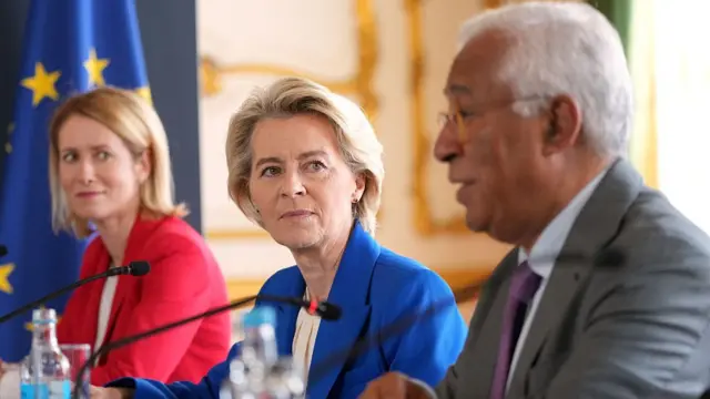 Kaja Kallas, Ursula von der Leyen, and Antonio Costa indoors, seated, speaking into small microphones.