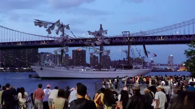 Spectators look at the damaged Mexican Navy ship on New York's East River