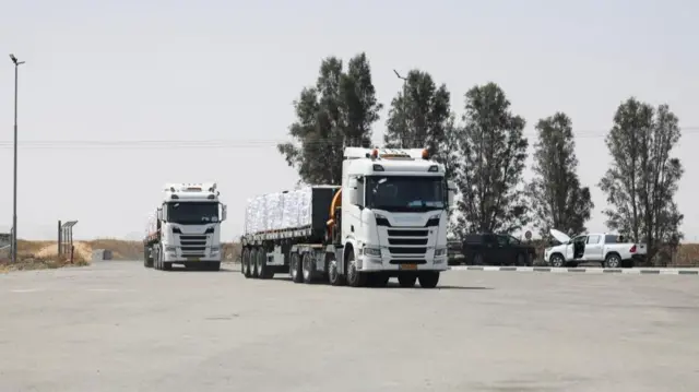 Trucks carrying aid, arrive at the Kerem Shalom crossing, as they make their way into Gaza, on the Israeli side of the crossing, May 19, 2025