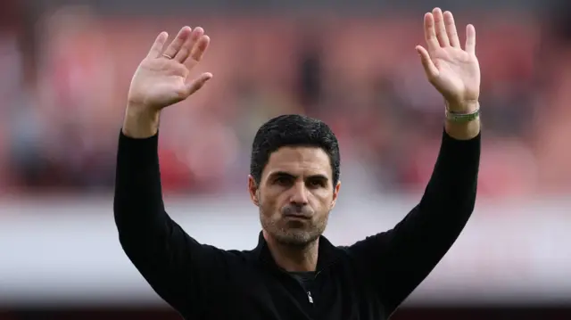 Manager Mikel Arteta waves to the Arsenal fans after his team's win over Newcastle