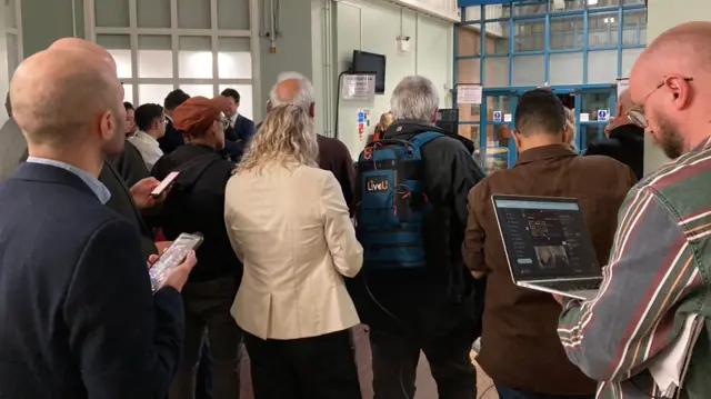 Journalists waiting by doors
