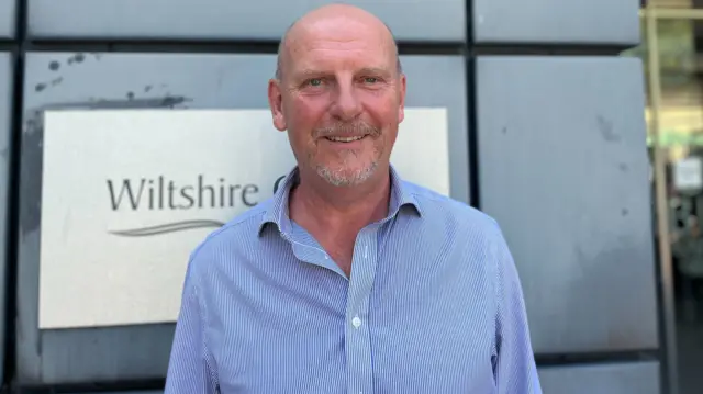 Nick Holder looks at the camera in front of the Wiltshire Council building
