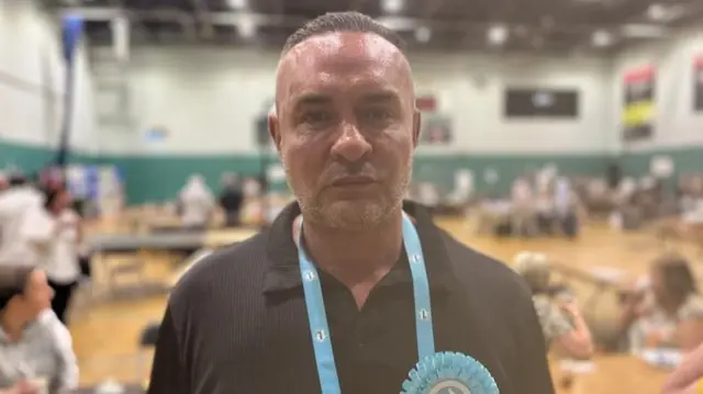 Noel Wilcox standing in an election count