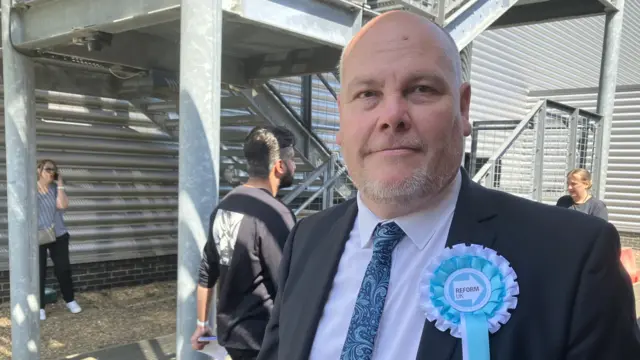 Paul Irwin standing outside a building