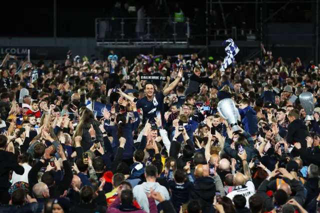 Liam Henderson is lifted high among the Falkirk crowds