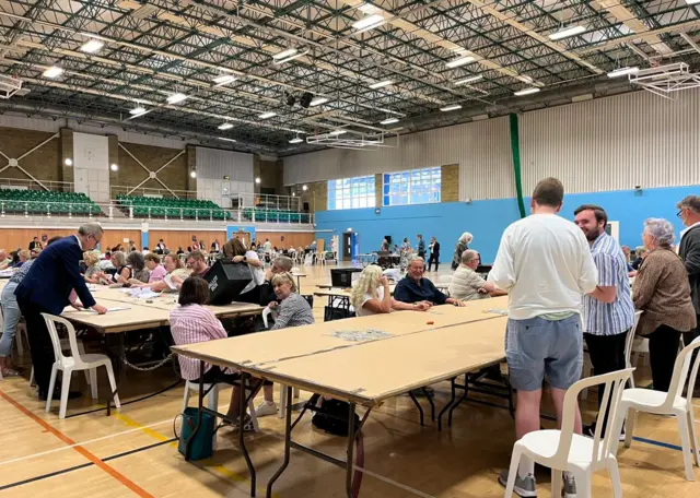 Volunteers beginning the process of sifting through votes.