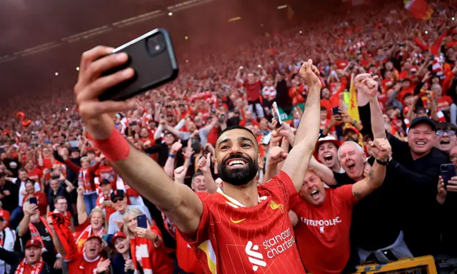 Mohamed Salah takes a selfie with fans at Anfield