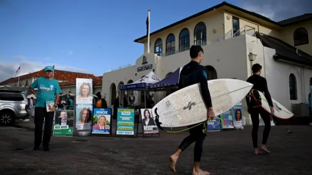 People carrying surfboards line up at the Bondi Surf Bathers Life Saving Club in Sydney on 3 May 2025