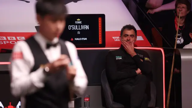 Ronnie O'Sullivan sits in his seat