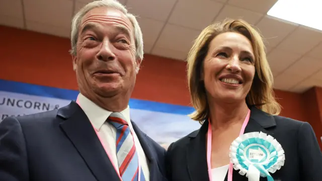Nigel Farage and Sarah Pochin smiling at an election count