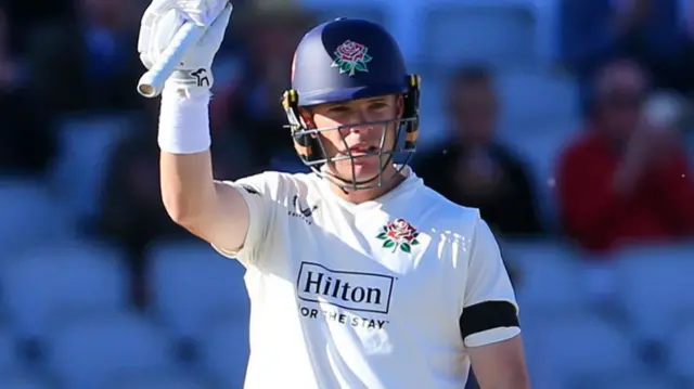 Marcus Harris celebrates reaching 150