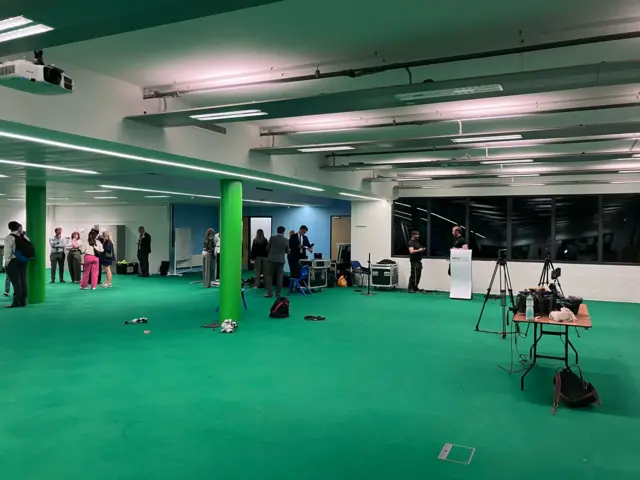 A school hall with a green carpet