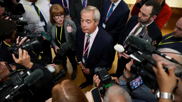 Nigel Farage interacts with the press