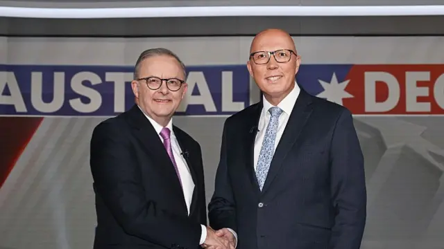 Australian Prime Minister Anthony Albanese shakes hands with Opposition leader Peter Dutton during the fourth and final leaders' debate.